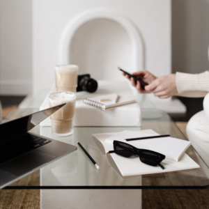 Promotional image for The Agency featuring a minimalist desk setup with a smartphone and note-taking materials, highlighting tips for brand and passive income growth.