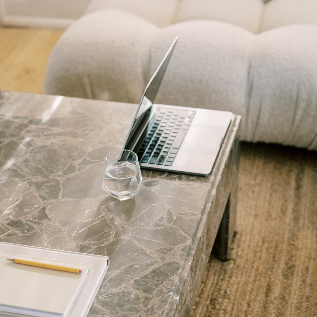 Modern feminine workspace with website wireframes and laptop open to homepage strategy
