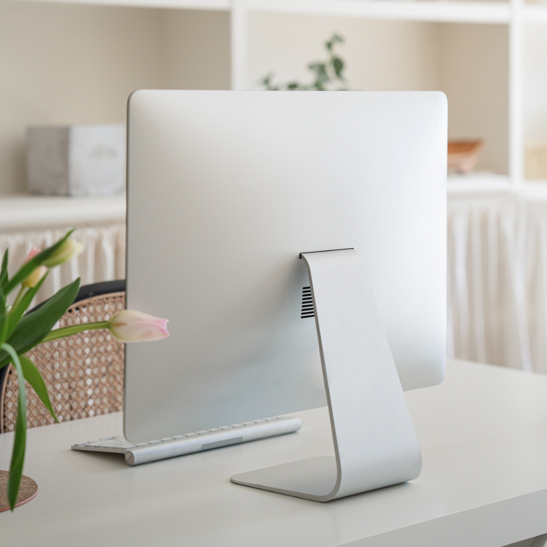 Flat lay of laptop and feminine workspace with website design notes, symbolizing a website refresh for modern brands