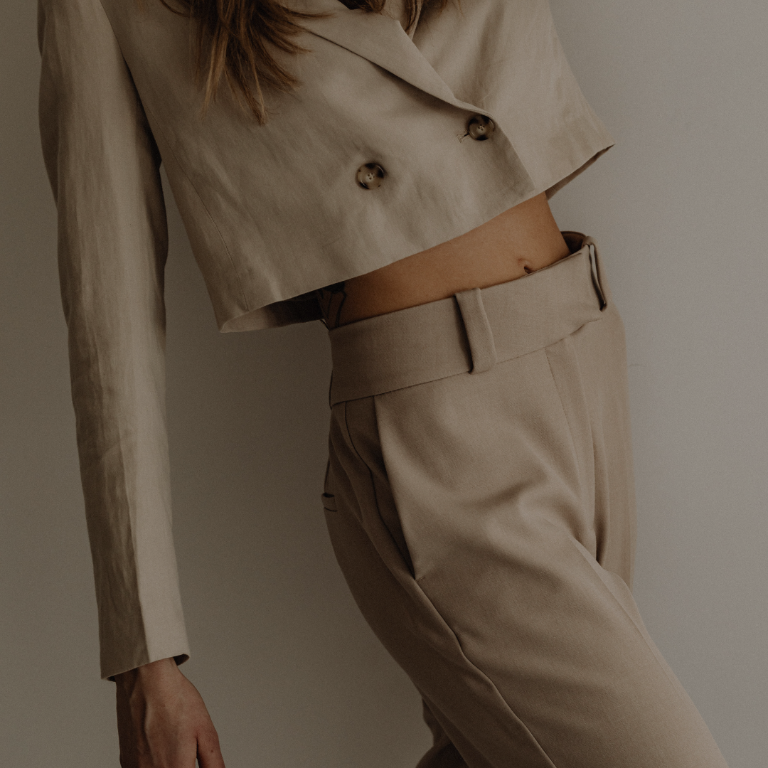 Woman in neutral-toned suit standing confidently with overlaid text: "Six Daily Shifts That Can Change Your Life